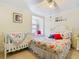 Cozy bedroom with a crib, window seat, and floral bedding creating a warm atmosphere at 5852 Medinah Way, Orlando, FL 32819