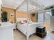 Bright main bedroom features a decorative canopy bed, tile floor, and lots of natural light at 5852 Medinah Way, Orlando, FL 32819