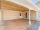 Spacious carport featuring a ceiling and access to a garage and pedestrian door at 5852 Medinah Way, Orlando, FL 32819