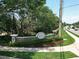 An inviting stone sign marks the entrance to Bay Hill, complemented by manicured landscaping at 5852 Medinah Way, Orlando, FL 32819