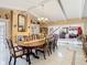 Bright dining room with a wooden table and views into the living room at 5852 Medinah Way, Orlando, FL 32819