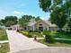 Exterior view of a tan home showing the front yard and landscaping at 5852 Medinah Way, Orlando, FL 32819