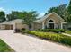 Charming home showcasing its landscaped front yard with a brick driveway at 5852 Medinah Way, Orlando, FL 32819