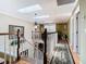 Bright upstairs hallway featuring hardwood floors, skylights, and a view of the staircase at 5852 Medinah Way, Orlando, FL 32819