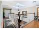 Bright upstairs hallway with skylights, hardwood floors, and artwork lining the walls at 5852 Medinah Way, Orlando, FL 32819