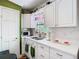 Bright eat-in kitchen featuring white cabinets, quartz countertops, and tiled backsplash at 5852 Medinah Way, Orlando, FL 32819
