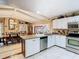 Open kitchen layout with stainless steel appliances, island, and dining area at 5852 Medinah Way, Orlando, FL 32819