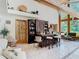 Living room featuring a bar area, vaulted wood ceilings and large windows at 5852 Medinah Way, Orlando, FL 32819