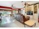 Living area with backyard view, leather couch, built-in shelving and tile floors at 5852 Medinah Way, Orlando, FL 32819