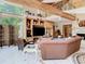 Open living room with high ceilings, wooden beams, large windows, and comfortable seating at 5852 Medinah Way, Orlando, FL 32819