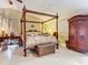 Elegantly furnished main bedroom with a four-poster bed and ample space at 5852 Medinah Way, Orlando, FL 32819