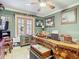 Comfortable office space with beautiful wooden desk, ceiling fan, and natural light from the window at 5852 Medinah Way, Orlando, FL 32819