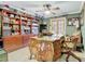 Beautiful office featuring a wooden desk, ceiling fan, built-in bookshelf, and abundant natural light at 5852 Medinah Way, Orlando, FL 32819