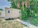 Backyard shed with neutral paint, double doors, and lush surrounding greenery at 5852 Medinah Way, Orlando, FL 32819