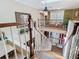 Elegant staircase featuring a light fixture, skylight, and a view into a sitting area with lots of light at 5852 Medinah Way, Orlando, FL 32819
