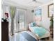 Bright sunroom with tiled floors, lounge seating, and outdoor access through glass paneled French doors at 5852 Medinah Way, Orlando, FL 32819