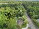 Aerial view of home that's surrounded by large trees and sits on a large lot with a grassy yard at 625 N Central Ave, Oviedo, FL 32765
