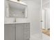 Bathroom featuring modern vanity, a large mirror, gold hardware and a door that opens to another room at 625 N Central Ave, Oviedo, FL 32765