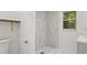 Bathroom featuring a tiled walk-in shower with gold hardware and a modern sink at 625 N Central Ave, Oviedo, FL 32765