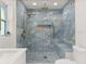 Stunning bathroom featuring blue marble-style tiles, a built-in bench, and modern gold fixtures at 625 N Central Ave, Oviedo, FL 32765