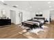 Well-lit main bedroom with white walls, laminate floors, ceiling fan, and a decorative rug at 625 N Central Ave, Oviedo, FL 32765
