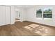 Spacious bedroom with light wood flooring, white walls, a closet, and windows with natural light at 625 N Central Ave, Oviedo, FL 32765