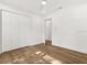 Neutral bedroom with hardwood floors, a ceiling fan, and a closet with mirrored doors at 625 N Central Ave, Oviedo, FL 32765