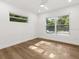 Bright bedroom with hardwood floors and ample natural light from two large windows at 625 N Central Ave, Oviedo, FL 32765