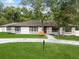 A charming one-story home boasts a well-manicured front yard and beautiful stone accents at 625 N Central Ave, Oviedo, FL 32765