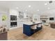 Stylish kitchen with an island and seating, opening into a living area with a fireplace at 625 N Central Ave, Oviedo, FL 32765
