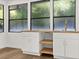 Kitchenette featuring white cabinets, wood countertop, a sink, and windows with greenery visible outside at 625 N Central Ave, Oviedo, FL 32765
