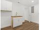 Laundry room featuring a new sink, wooden countertops, and bright white cabinets at 625 N Central Ave, Oviedo, FL 32765