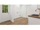 Laundry room with sink, wooden countertops, and a door that leads outside at 625 N Central Ave, Oviedo, FL 32765