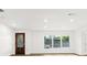 A bright living room featuring hardwood floors, recessed lighting, and a decorative front door at 625 N Central Ave, Oviedo, FL 32765