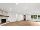 The open-concept living area has updated flooring, a beautiful stone fireplace, and recessed lighting at 625 N Central Ave, Oviedo, FL 32765