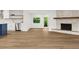 Open-concept design with updated flooring, stainless steel appliances and a stone fireplace at 625 N Central Ave, Oviedo, FL 32765