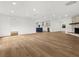 Spacious living room with open layout, hardwood floors, and views of the modern kitchen at 625 N Central Ave, Oviedo, FL 32765