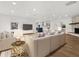 Bright, open-concept living room with hardwood floors, fireplace, and view into modern kitchen at 625 N Central Ave, Oviedo, FL 32765