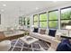 Living room featuring a modern interior with a large rug and lots of natural light from the windows at 625 N Central Ave, Oviedo, FL 32765