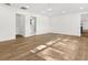 Spacious room featuring laminate flooring, white walls, and windows that provide plenty of natural light at 625 N Central Ave, Oviedo, FL 32765
