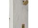 Shower showcasing bright marble tile with a gold-colored shower head at 625 N Central Ave, Oviedo, FL 32765