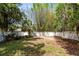 Inviting backyard with mature trees and white fence offering a private outdoor space for relaxation and enjoyment at 657 Overspin Dr, Winter Park, FL 32789