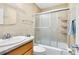 Cozy bathroom features tile walls, shower with sliding glass doors, and a vanity with a sink at 657 Overspin Dr, Winter Park, FL 32789