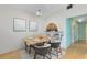 Dining room features light wood floors, dining table with seating for four, and decorative art pieces at 657 Overspin Dr, Winter Park, FL 32789
