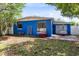 Charming single-story home with vibrant blue exterior and well-manicured front yard creating a welcoming curb appeal at 657 Overspin Dr, Winter Park, FL 32789