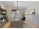 Functional home office boasts a large desk, ample shelving, and natural light, perfect for productivity and focus at 657 Overspin Dr, Winter Park, FL 32789