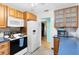 Functional kitchen featuring plenty of cabinet space, a modern refrigerator, and a white microwave at 657 Overspin Dr, Winter Park, FL 32789