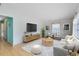 Cozy living room featuring a large screen TV, comfortable couch, and accent chairs at 657 Overspin Dr, Winter Park, FL 32789