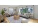 Bright living room with large windows, comfortable seating, and a stylish round coffee table at 657 Overspin Dr, Winter Park, FL 32789