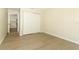Bright bedroom featuring neutral walls, light wood flooring and a closet with bi-fold doors at 662 Kenwick Cir # 102, Casselberry, FL 32707